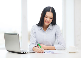 smiling businesswoman or student with laptop