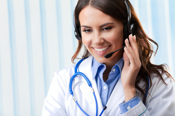 Young female doctor on phone, at office