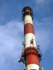 red-white high concrete chimney outlet of heat