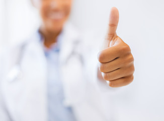 female doctor showing thumbs up