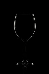One elegant wine glass on black background.