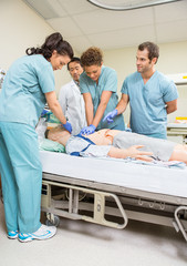 Medical Team Performing CPR On Dummy Patient