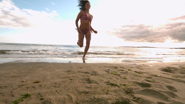 Woman running away from sea