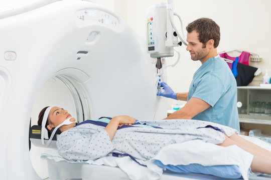 Nurse Looking At Patient Undergoing CT Scan