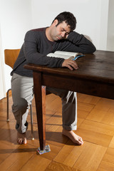 portrait of man sleeping on the wooden table