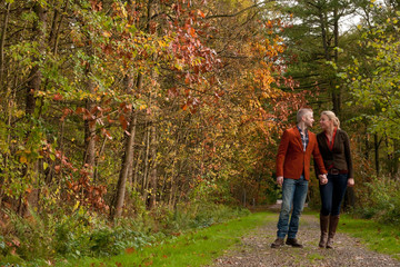 Happy couple is taking a walk in the forest