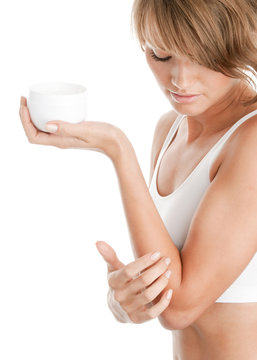 Woman Applying Body Lotion On Her Elbow