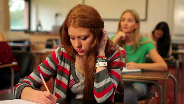 Blonde student thinking in class