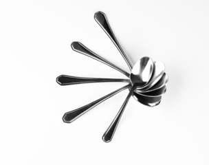 Set of stainless steel spoon patterning  a flower on white backg
