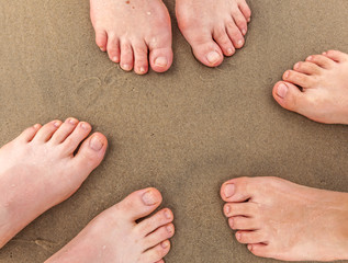 feet of family at the beach