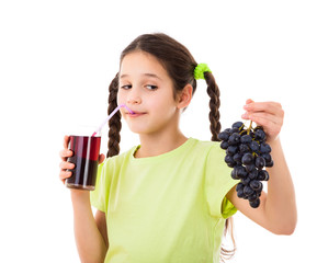 Smiling girl drinking jiuce with grape in hands