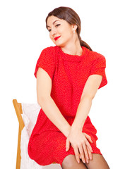 Pretty woman sitting on a chair with her hands folded