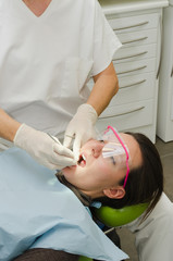 Hands of dentist working on patient