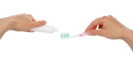 Female hands with toothpaste and brush