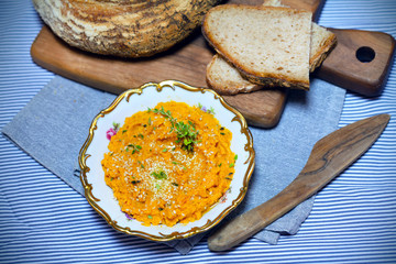 Carrot and pumpkin dip, spread with sourdough bread