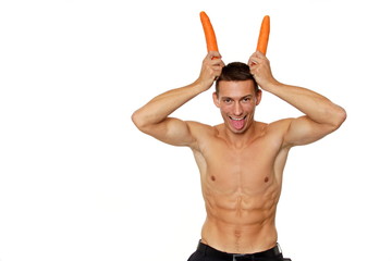 Young man with horns on his head from carrots