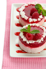 Delicious berry cakes on plate close-up