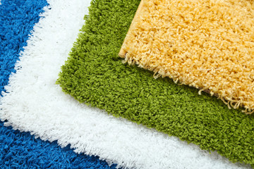 Many carpets of different colors close-up