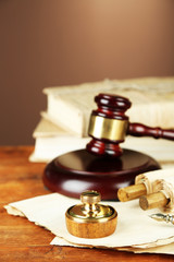 Wooden stamp, gavel and old papers on wooden table
