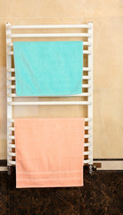 Fototapeta premium Color towels on radiator in bathroom