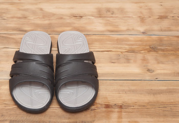 black flip flops on wooden deck. summer background