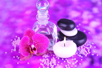 Obraz na płótnie Canvas Spa oil with orchid on purple background