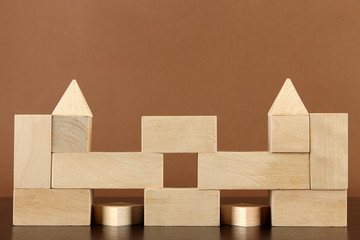 Wooden toy blocks on table on brown background
