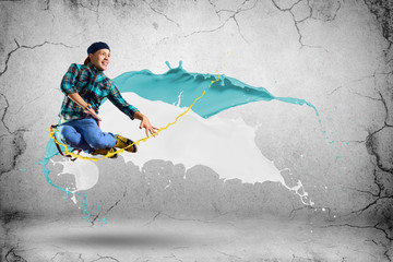young male dancer jumping with splash of paint