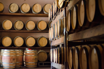 Wine barrels stacked in the cellar.