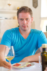 Man with glass of white wine.