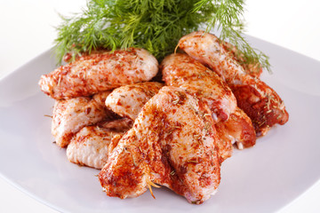 fresh chicken wings in sauce ready for frying