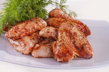 .fresh chicken wings in sauce ready for frying