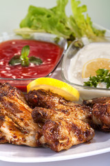 fried chicken wings in sauce with mayonnaise and tomato sauce