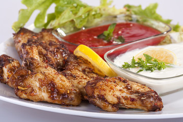 fried chicken wings in sauce with mayonnaise and tomato sauce