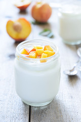 Yougurt with peaches slice. Selective focus
