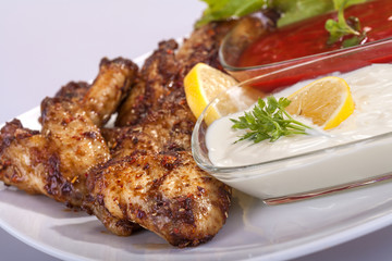 fried chicken wings in sauce with mayonnaise and tomato sauce