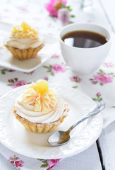 Tart with whipped cream and a cup of tea on the table
