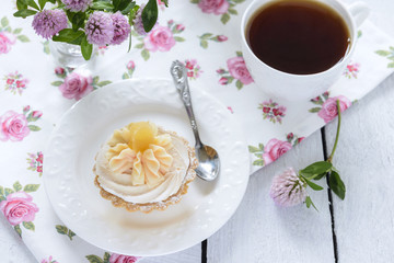 Tart with whipped cream and a cup of tea