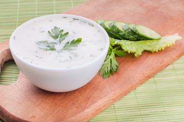cold cucumber soup with slices of cucumber