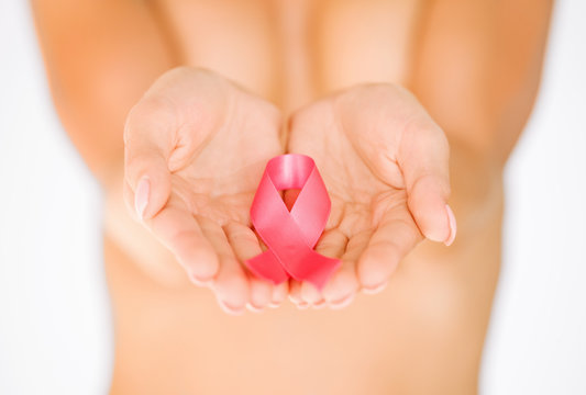 hands holding pink breast cancer awareness ribbon
