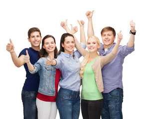 group of smiling students showing thumbs up