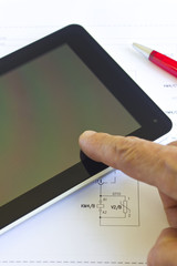 Man working with tablet computer over engineering diagram