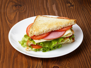toasted sandwich with ham, cheese and vegetables