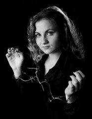 portrait of woman wearing handcuffs from barbwire