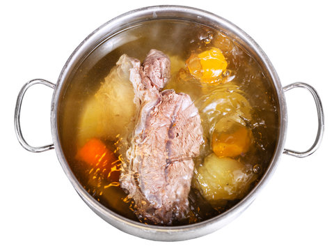 open steel pan with cooking beef broth