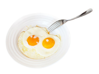 breakfast with two fried eggs in white plate
