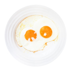 breakfast with two fried eggs in white plate