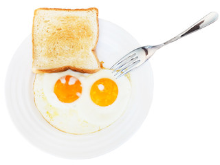 breakfast with two fried eggs in white plate