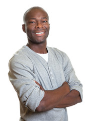 Attractive african man with crossed arms laughing at camera