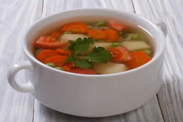 Vegetable soup with peas, onions, carrots, potatoes and tomatoes